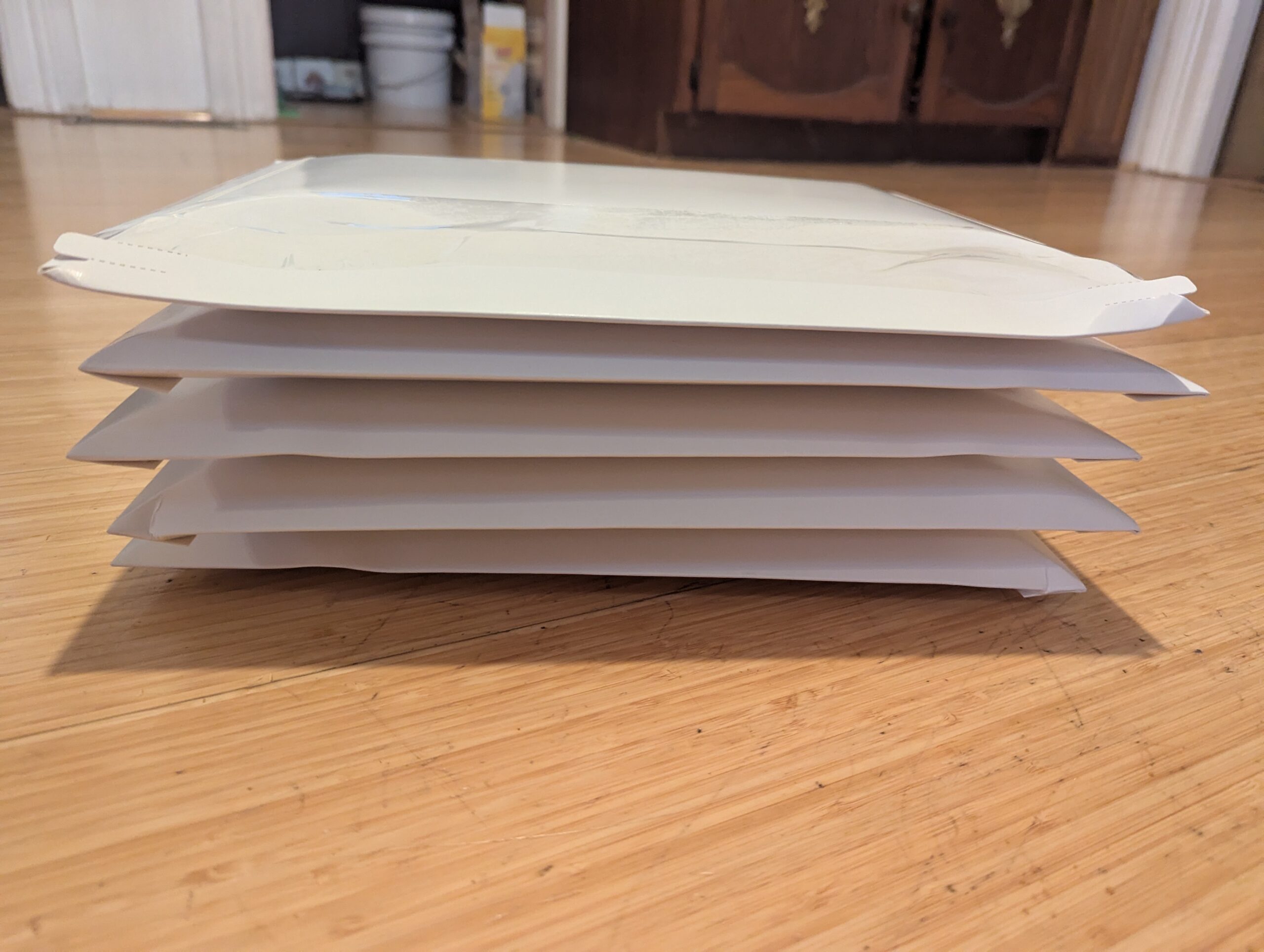 Pile of mailing envelopes containing The Expert of Subtle Revisions by Kirsten Menger-Anderson