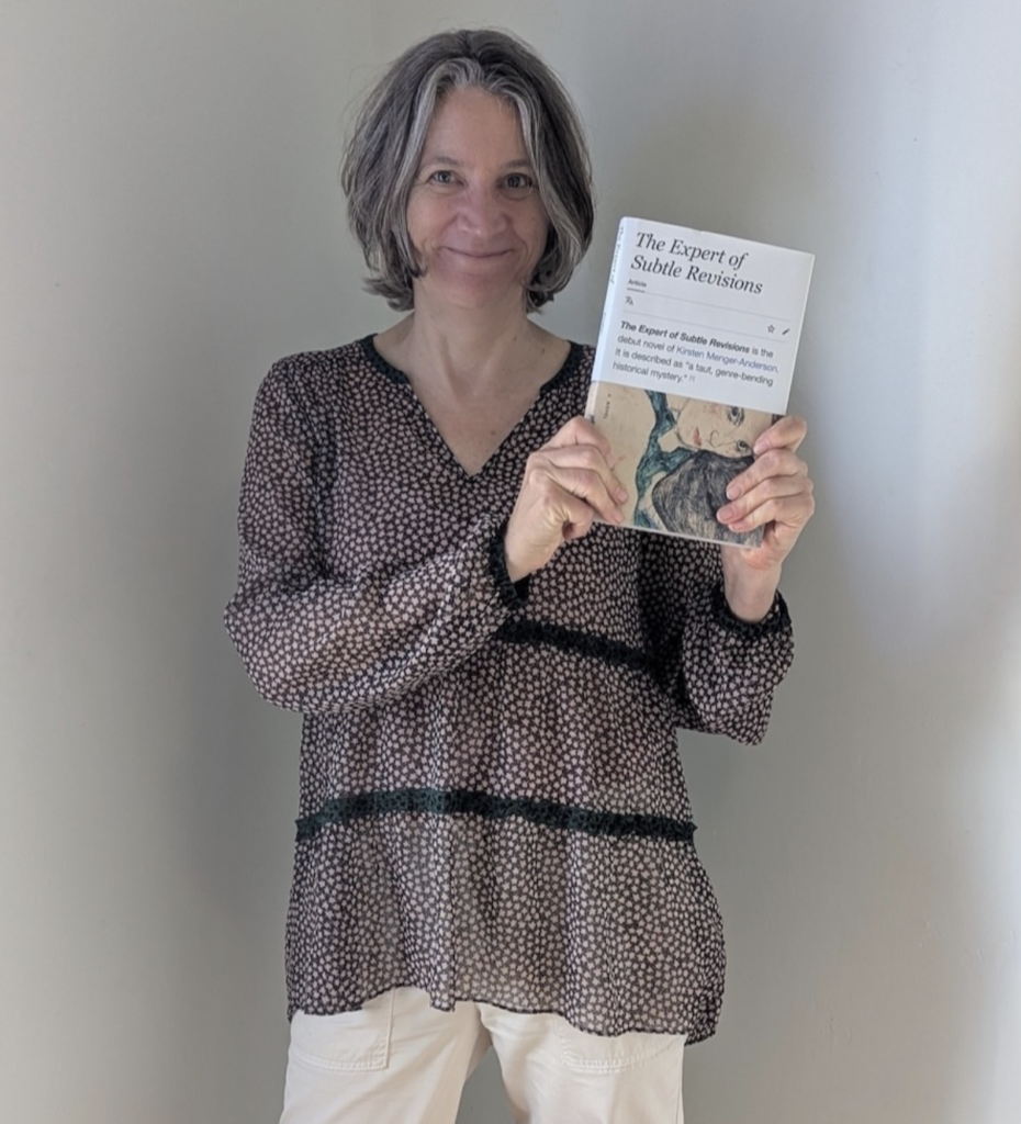 Author Kirsten Menger-Anderson with her novel The Expert of Subtle Revisions
